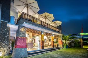 a house with two large umbrellas on top of it at Villa Kirani Ubud by Mahaputra-CHSE Certified in Ubud