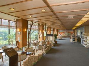 a hallway with tables and chairs in a building at Kagamigaike Hekizantei in Nihommatsu