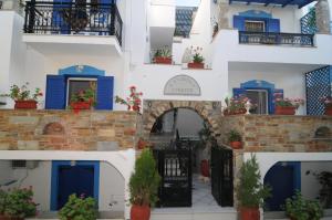 a building with blue doors and a gate at Studios Stratos in Naxos Chora