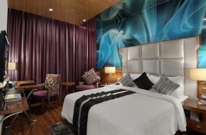 a hotel room with a bed and a desk at The Elanza Hotel, Bangalore in Bengaluru +32 photos