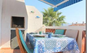 a table with a blue and white table cloth on a patio at 22B puigmal D in Empuriabrava