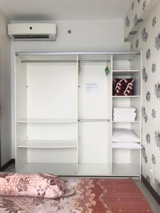 a white refrigerator with its doors open in a room at Scientia Residences Gading Serpong by Taslim in Serpong +13 photos