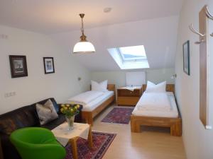 a room with two beds and a couch and a window at Ferienwohnungen Anneliese&Fritz Wagerer in Rimbach