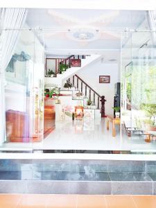 a living room with a glass wall at Homestay Gia Phú in Con Dao