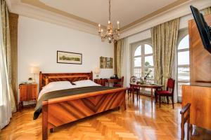 a bedroom with a large wooden bed and a desk at Hotel Vittoria in Brescia