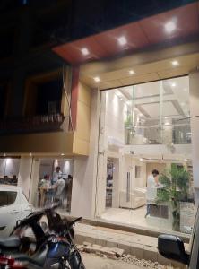 a motorcycle parked in front of a store window at Hotel Kaveri in Allahābād