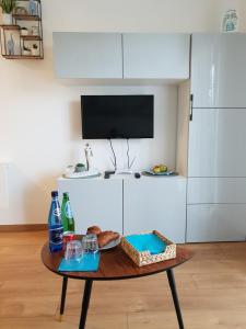 a table with a tray of bread and drinks on it at Apartament Nad Starą Odrą in Wrocław