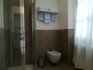 a bathroom with a shower and a toilet and a sink at I Love Varenna in Perledo