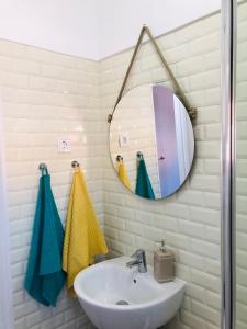 een badkamer met een wastafel en een spiegel bij Sea & Beach Apartment in Costa da Caparica