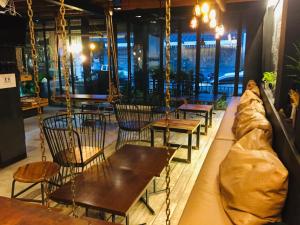 a row of chairs and tables in a restaurant at Phuket Sunny Hostel in Phuket Town