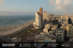 a view of a city with a beach and buildings at Modern 2BR Apt w Private Parking in City Center by Sea N' Rent in Ramat Hash Sharon
