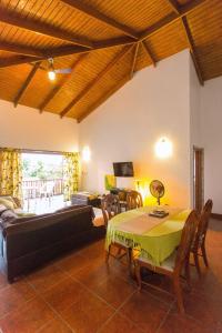 a living room with a table and a couch at Palm View in Laborie