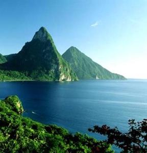 a large body of water with mountains in the background at Palm View in Laborie