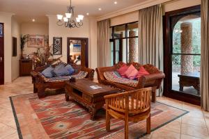 a living room filled with furniture and a fireplace at AmmaZulu African Palace in Kloof