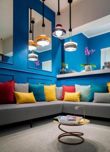 a living room with a couch with colorful pillows at Residenza del Borgo in Bergamo