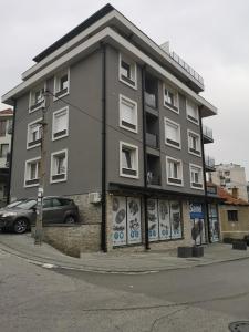 a building with graffiti on it on a street at ANA LUX in Užice