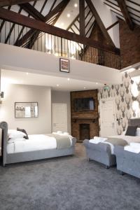 a large bedroom with two beds and a fireplace at The Glebe Hotel in Liverpool