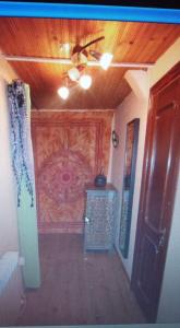 a hallway with a wall with a wooden ceiling at Villa Alejandra in Cudillero