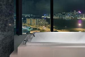 a bathroom sink with a view of a city at night at Hotel ICON in Hong Kong