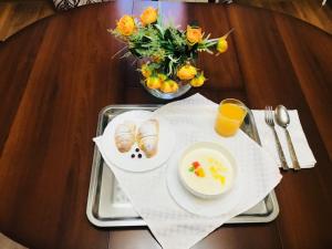 a tray with a plate of food and a bowl of oranges at Sultan Beibarys in Astana