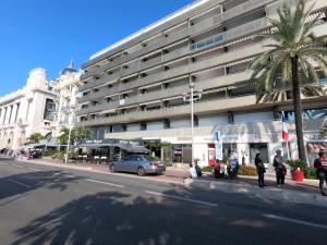 a large building with a car parked in front of it at Royal Promenade in Nice