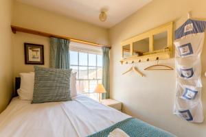 a bedroom with a bed and a window at 5 Coastguard Cottages in Aldeburgh