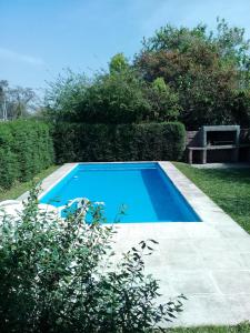 a blue swimming pool in the middle of a yard at La Providencia in Yerba Buena