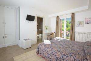 Postel nebo postele na pokoji v ubytování Hotel Degli Olmi
