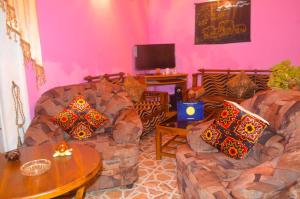 a living room with two couches and a table at Linda Cottage in Galle
