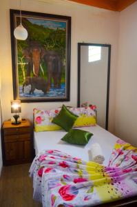 a bedroom with a bed and a picture of an elephant at Linda Cottage in Galle +159 photos