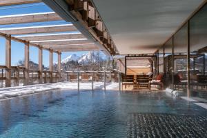 a swimming pool with a view of a mountain at Bürgenstock Hotels & Resort - Waldhotel & Spa in Bürgenstock