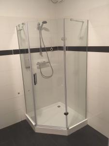a shower with a glass enclosure in a bathroom at Aan't Kanaal in Harlingen