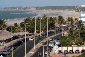 a parking lot with a lot of cars and a beach at Roma Garden in São Luís