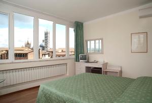 Postel nebo postele na pokoji v ubytování Hotel Duomo