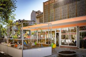 a store front with chairs and tables in a city at Family Hotel Varna in Varna City