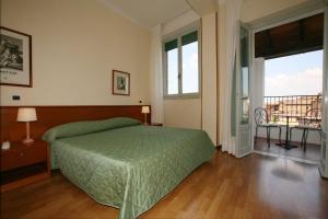Postel nebo postele na pokoji v ubytování Hotel Duomo
