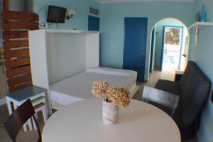 a room with a white table and a room with a bedroom at Agi Marina Apartments in Roses