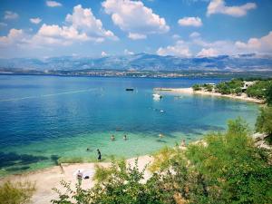 a group of people in the water at a beach at Apartment Novigrad Holiday in Novigrad Dalmatia