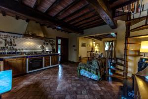 a living room with a kitchen with a stove top oven at La Casa Degli Olmi in Empoli