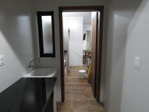 a bathroom with a sink and a mirror at Residencial Sol e Lua in Palhoça