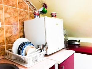 a kitchen counter with a dish drying rack next to a refrigerator at Vila Aleksandar in Smederevo