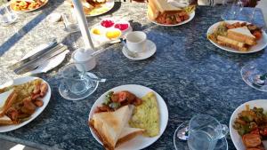 a blue table with plates of food on it at Panorama Guest House in Nagarkot