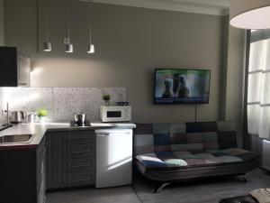 a kitchen with a couch in the corner of a kitchen at Apartament Easy Stay Center in Wrocław