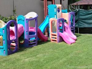 a group of childrens play equipment on the grass at Pokoje u Szlachty in Szczawnica