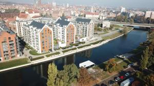 an aerial view of a city with a river and buildings at Dom na Wodzie - Flohotel in Gdańsk