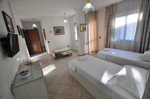 Postel nebo postele na pokoji v ubytování Aparthotel Shkodra