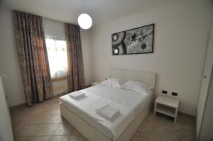 Postel nebo postele na pokoji v ubytování Aparthotel Shkodra
