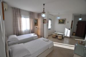 Postel nebo postele na pokoji v ubytování Aparthotel Shkodra