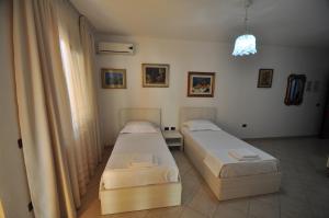 Postel nebo postele na pokoji v ubytování Aparthotel Shkodra