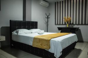 Postel nebo postele na pokoji v ubytování Hotel Escorial Ibagué